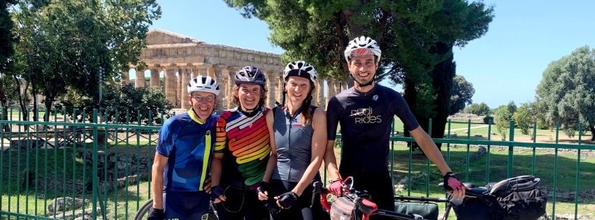 Groep fietsers met Rudi Rides bij Griekse tempel in Paestum in Zuid Italië