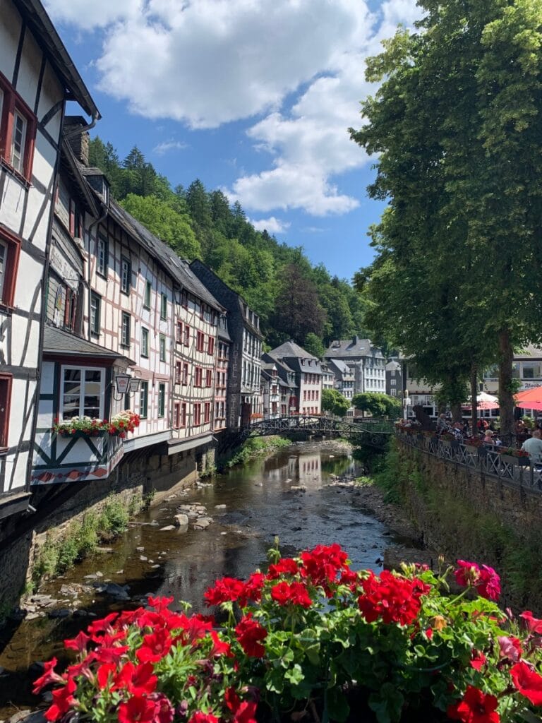 Centrale plein in Monschau met rode bloemen en op de achtergrond restaurant hotel Zum Stern.