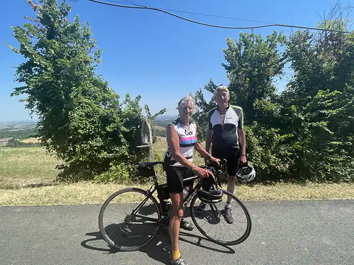 a couple of people standing next to bicycles